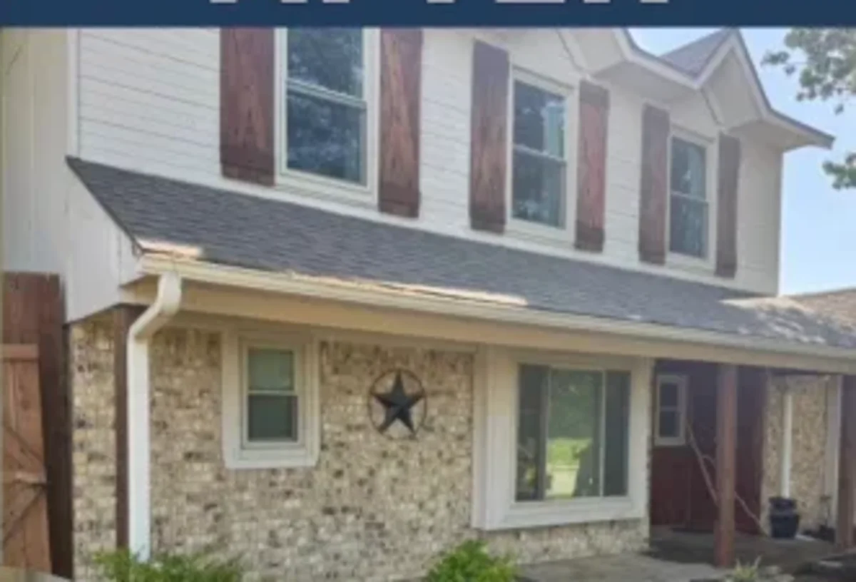 The same brick two story home after the foundation was lifted three inches and the yard restored